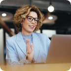 A businesswoman speaks holds a virtual meeting using her laptop.   